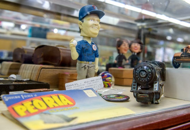 A vintage autographed bobblehead of the late Peoria Chiefs owner Pete Vonachen, sits in a display case of collectibles at the A-Z Jewelry & Swap shop in downtown Peoria.
