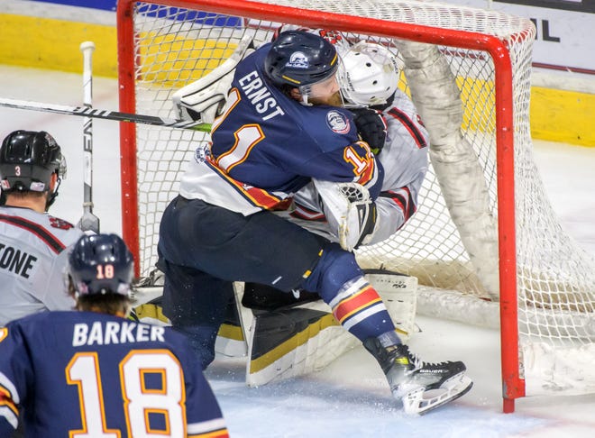 Peoria's Jordan Ernst (11) collides with Huntsville goaltender Mike Robinson in the net in the third period of Game 2 of the SPHL President's Cup finals Saturday, April 27, 2024 at the Peoria Civic Center. The Rivermen forced a Game 3 with a 6-4 victory.