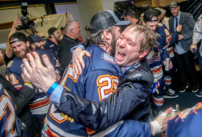 Peoria's Tristan Trudel, left, hugs Jason Ruff, the team's director of communication and broadcasting, after helping douse him in beer while celebrating the team's 5-1 win over the Huntsville Havoc in the deciding game of the SPHL President's Cup finals Sunday, April 28, 2024 at the Peoria Civic Center.