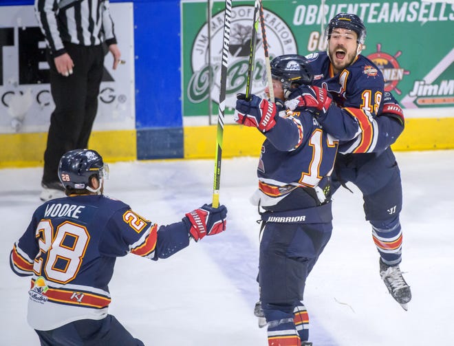 Peoria's Zach Wilkie (19) jumps on teammate Alec Hagaman as Meirs Moore skates in to celebrate Hagaman's empty-net goal in the third period of the deciding game of the SPHL President's Cup finals Sunday, April 28, 2024 at the Peoria Civic Center.