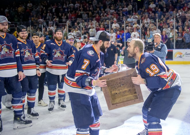 Peoria's Zach Wilkie, right, passes the President's Cup to teammate Joe Drapluk as the Rivermen celebrate their 5-1 victory over the Huntsville Havoc in the deciding game of the SPHL President's Cup finals Sunday, April 28, 2024 at the Peoria Civic Center.
