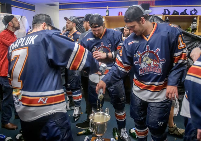 Peoria Rivermen players fill the President's Cup with beer as they celebrate their 5-1 victory over the Huntsville Havoce in the deciding game of the SPHL President's Cup finals Sunday, April 28, 2024 at the Peoria Civic Center.