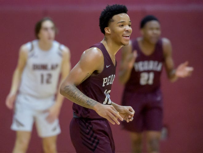 Peoria High's MikeQuese Taylor (10) smiles as the Lions extend their lead against Dunlap in a high school basketball game on Jan. 17, 2023. Taylor was shot and killed in Peoria on April 30, 2024.