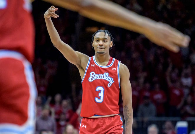 Bradley's Zek Montgomery signals three points after a Braves three-pointer against Drake late in the second half Sunday, Feb. 26, 2023 at Carver Arena. The Braves defeated the Bulldogs 73-61.